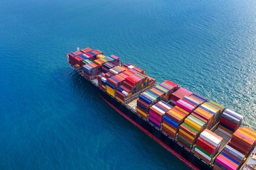Aerial view of container cargo ship in sea. - obrazy, fototapety, plakaty