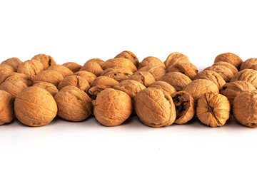 a large number of walnuts on a white background