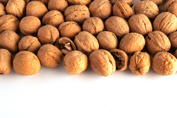 a large number of walnuts on a white background