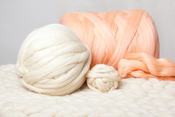 a ball of thick yarn and a blanket of thick wool
