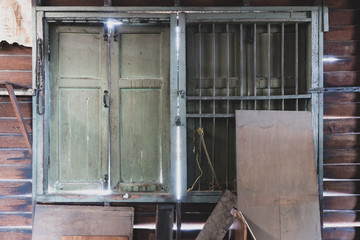 The window of an old wooden house in a slum