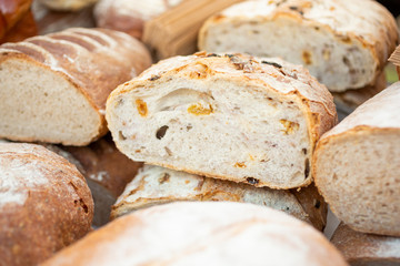 A view of several cut loaves of fresh artisan bread on display at a local bakery.