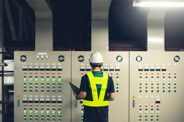 Electrical Engineer team working front control panel, Technician daily check control panel in...