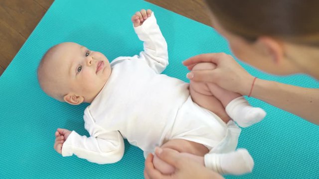 Baby boy getting a massage from mother