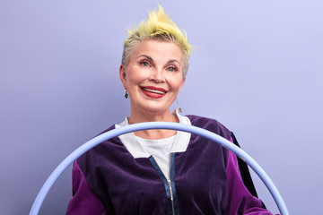 old positive woman attends fitness classes. close up portrait. woman having a rest during training...