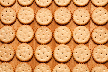 Round crackers on wood background. Top view