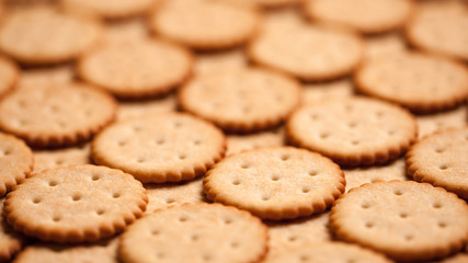 Background of round crackers. Shallow depth of field