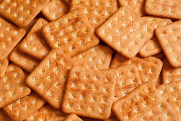 Square salty crackers in natural light. Top view
