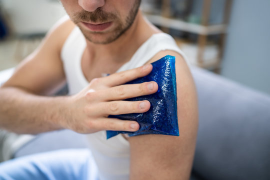 Man Applying Ice Bag On His Shoulder