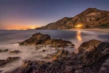 Fototapeta na wymiar Rocks in the beach at night