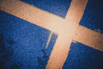 Fototapeta na wymiar yellow cross on the pavement