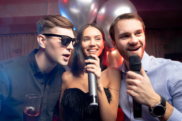 young caucasian people celebrating birthday in karaoke bar, chill out. holiday, celebration, party...