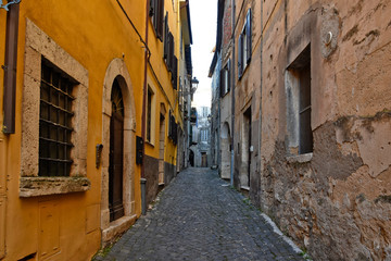 Fototapeta na wymiar Alatri, Italy, 01/03/2020. A narrow street between the old houses of a medieval village