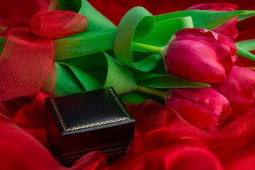 red tulips gol ring box on red background © Golden Shark