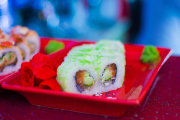 sushi rolls cooked on a plate in a restaurant