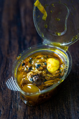 Indian Food Sauce with Garlic, Cardamom, Currants and Various Spices in Plastic Box Package / Container.