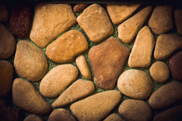 Fototapeta na wymiar pebble wall round stone background texture