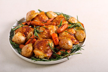 Roast chicken thighs with potatoes, carrot and rosemary