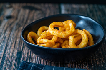 Spicy Seasoned Curly Fries Ready to Eat with Sauce.