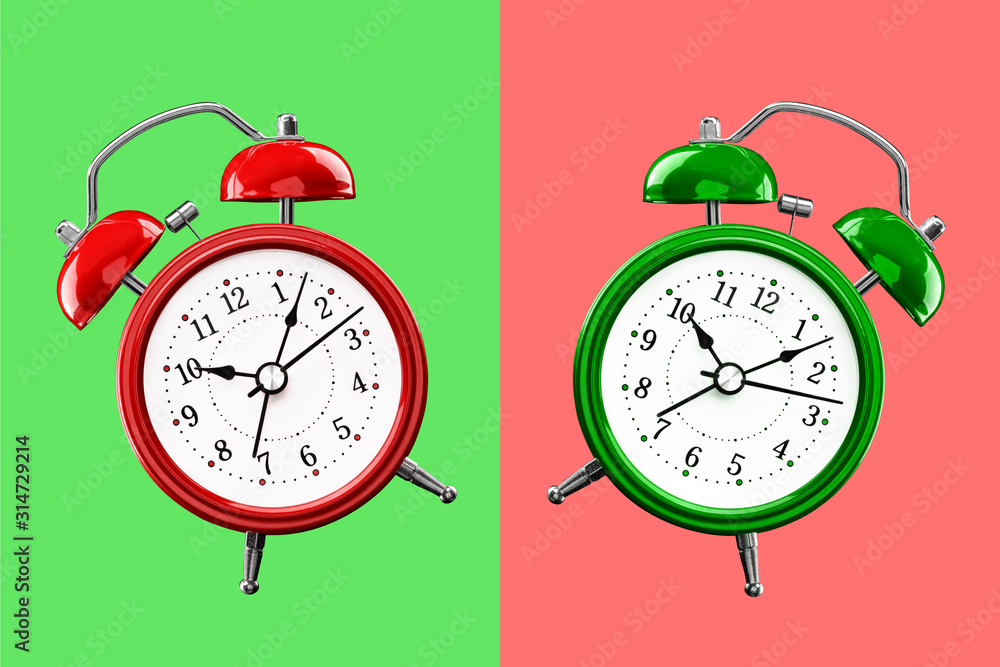 Wall mural Two colored alarm clocks on a background of colored squares of the opposite color.