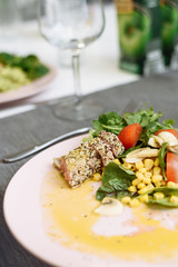 Salad of greens, canned corn and fried tuna in sesame seeds. Recipe for an expensive fish