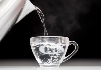 Pour hot water into a clear glass