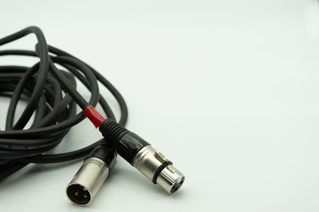black xlr cable on white background, music concept