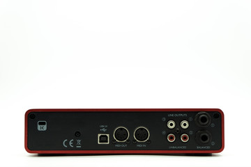 USB Audio interface back view of the panel with plugs for connection, external sound card red color...