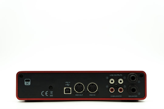 USB Audio interface back view of the panel with plugs for connection, external sound card red color on white background