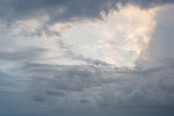 a heart shaped cloud surrounded by dark clouds
