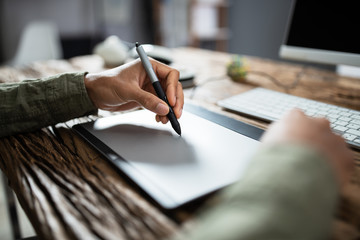 Businessman Writing On Graphic Tablet