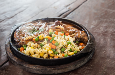close up pork steak on hot pan serve