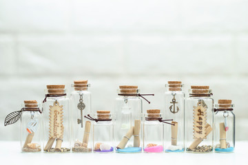 Small shells in many small glass bottles