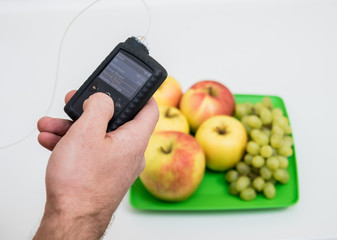 Diabetic man with an insulin pump connected in his abdomen. insulin pump calculates the dose of...