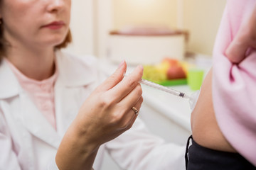 Doctor makes an injection of insulin with a catheter. Doctor injects insulin to a patient with...