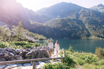 guy and girl walking and holding hands. couple in love. mountain