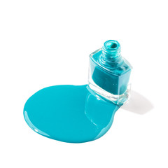 Colored nail polish is spilled on a white background