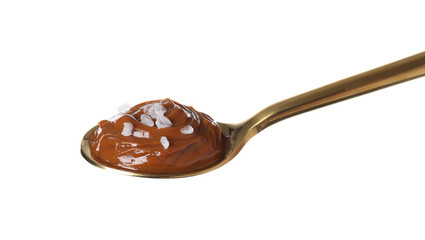 Salted caramel in spoon isolated on white
