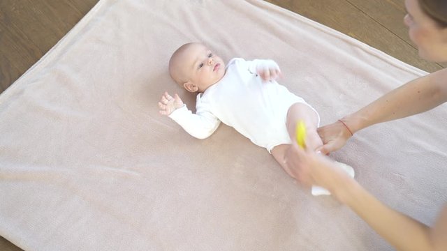Baby boy getting a massage from mother