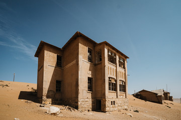 abandoned big house on a high desert plain