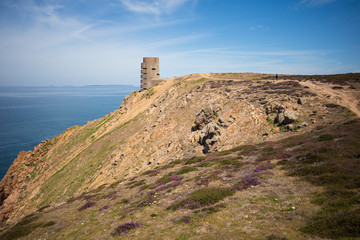Fototapeta na wymiar Barren rocky coast with MP3 tower from the occupation