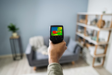 Person Hand Using Infrared Thermal Camera In Living Room