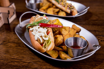 Hotdogs and French fries on a dishes. Fast food meal. Restaurant.