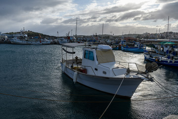 Fototapeta premium Small fishing boat moored in the port