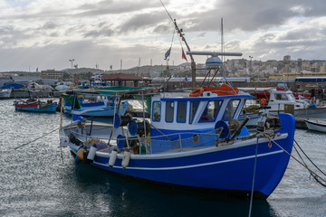 Small fishing boat moored in the port