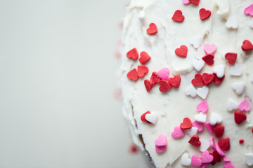 Obraz na płótnie Canvas Vanilla cake with heart sprinkles for St. Valentin's Day.