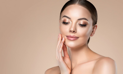 Beautiful young woman with clean fresh skin on face . Girl facial  treatment   . Cosmetology ,...