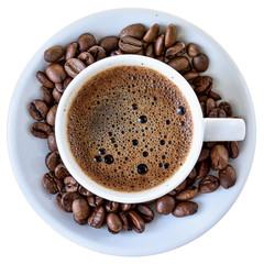 Cup of hot coffee and a scattering of coffee beans isolated