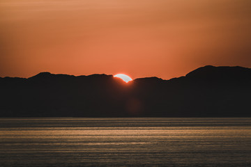 Beautiful Sunset with mountains and icebergs. Arctic circle and ocean. Sunrise horizon with pink...
