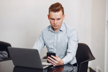 Handsome man in a blue shirt. Businessman working in a office